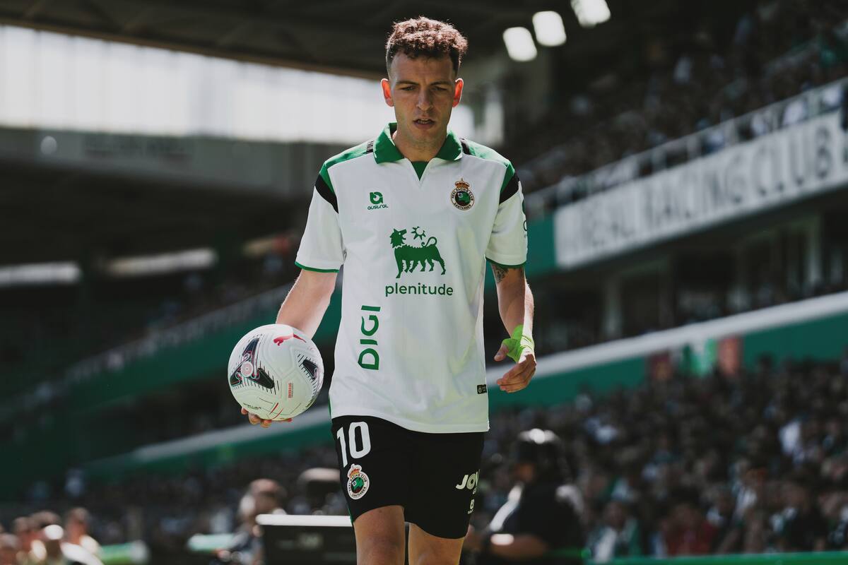 Racing player walking onto the pitch with a ball
